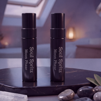 Two Soul Spritz Moon Phase herbal sleep spray vials on a marble nightstand at dusk